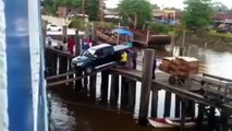 truck loading into a cargo ship via planks