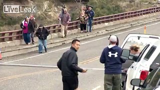 Video: Tourists try to act casual as they flee mama bear