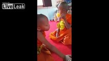 Child Monk has a Hard Time Staying Awake During Morning Buddhist Ritual Prayer.