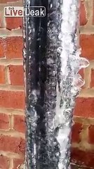 Download Video: Ice on this frozen pipe is melting from the inside out, creating a waterfall inside