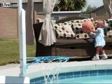 father throws his  little daughter in the swiming pool