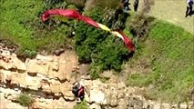 Dramatic rescue of a female paraglider trapped 85 feet up on cliff face