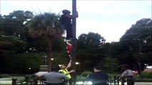 Woman climbing pole and removing Confederate flag from outside South Carolina statehouse