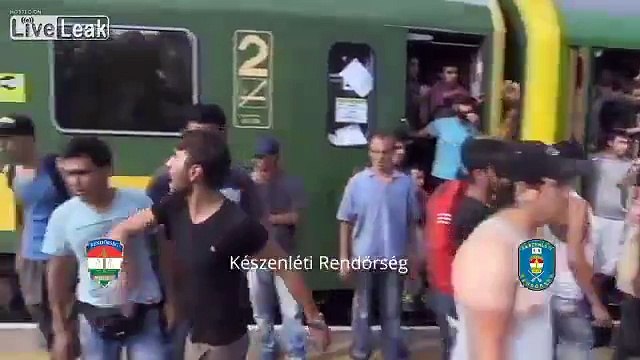Syrian refugees throwing water and food away provided to them by Hungarians in sign of protest.