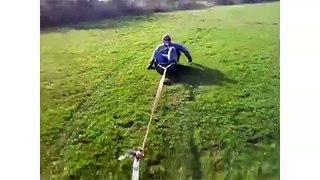 Co-Workers Laugh Their Way Around a Muddy Field While Towed by a Truck