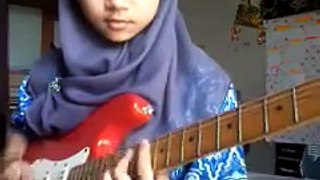 Muslim girl playing the guitar