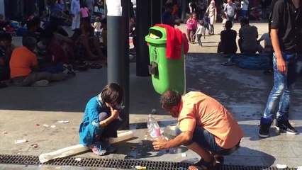 Crowds beg for food and water at Budapest station