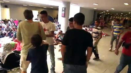 Un homme apporte de la nourriture à des migrants