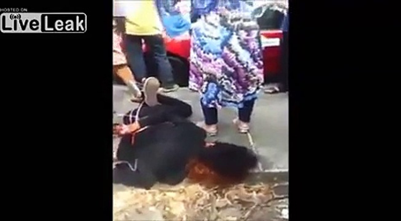 Alleged Thief Is Hog Tied And Given Some Street Justice Before The Police Take Him Away.