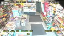 Woman fights off two knife wielding robbers in Belfast store.