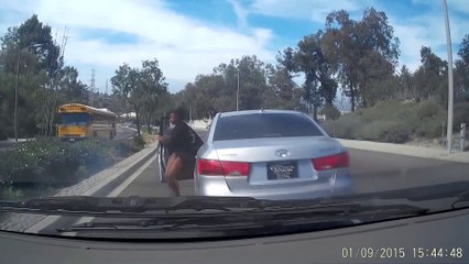 Woman jumps out of her car and causes accident!