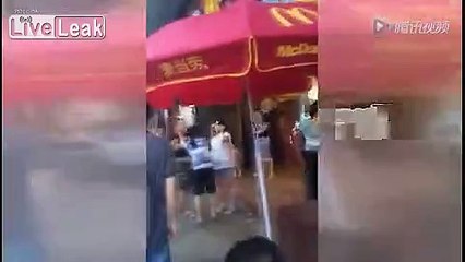 Women fight over two cups of milk in front of McDonald's