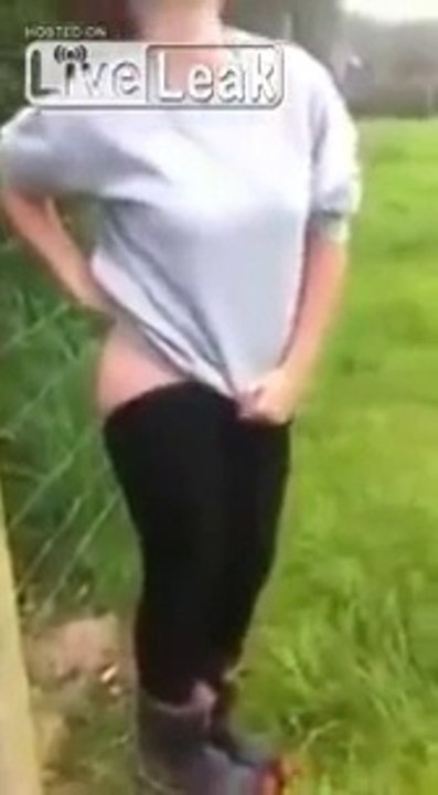 Naked ass of  American girl and fence with electric voltage