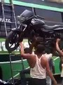 Insane: Guy Carries A Motorbike On His Head Up A Ladder!