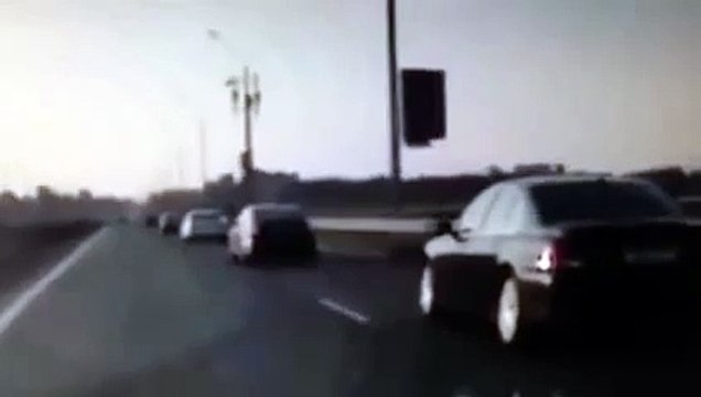 Motorcycle crash, rider flips and lands on feet on car roof