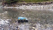 RC Unimog 6X6 hauling Subaru Impreza rally car across river