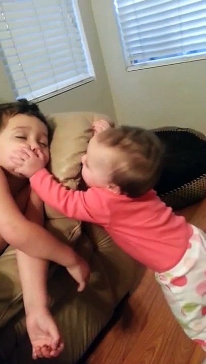 Baby sister tries to wake her big brother
