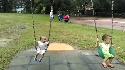 Funny kids gleefully enjoy playing swing