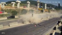 Car gets crushed between cement barriers and truck