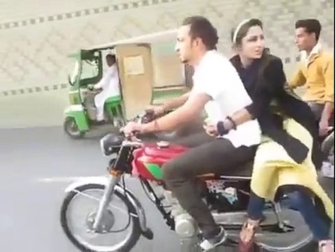 Pakistani Boy With A Girl Doing One Wheeling On Bike