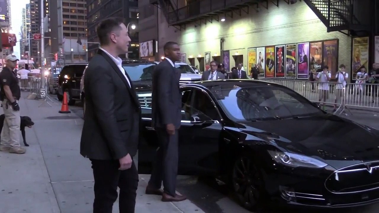 Elon Musk greeting fans .