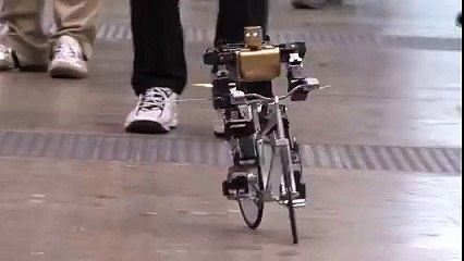 PRIMER-V2 robot rides a bike just like a man.