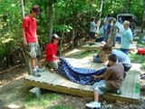 Boy Scouts demonstrate building a stretcher