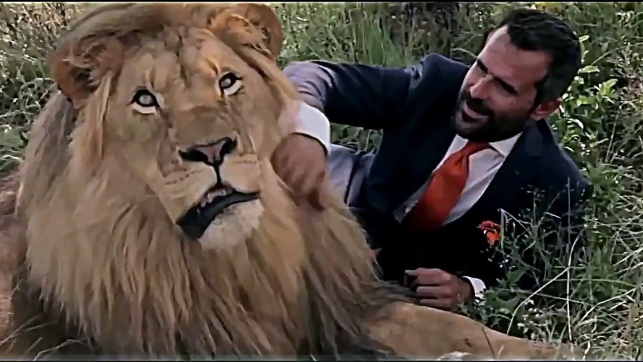 National Geographic   man plays football with a lion