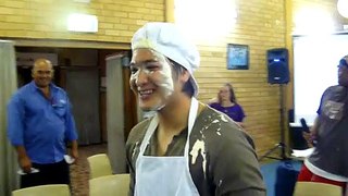 Grace throwing pie in Gez's face