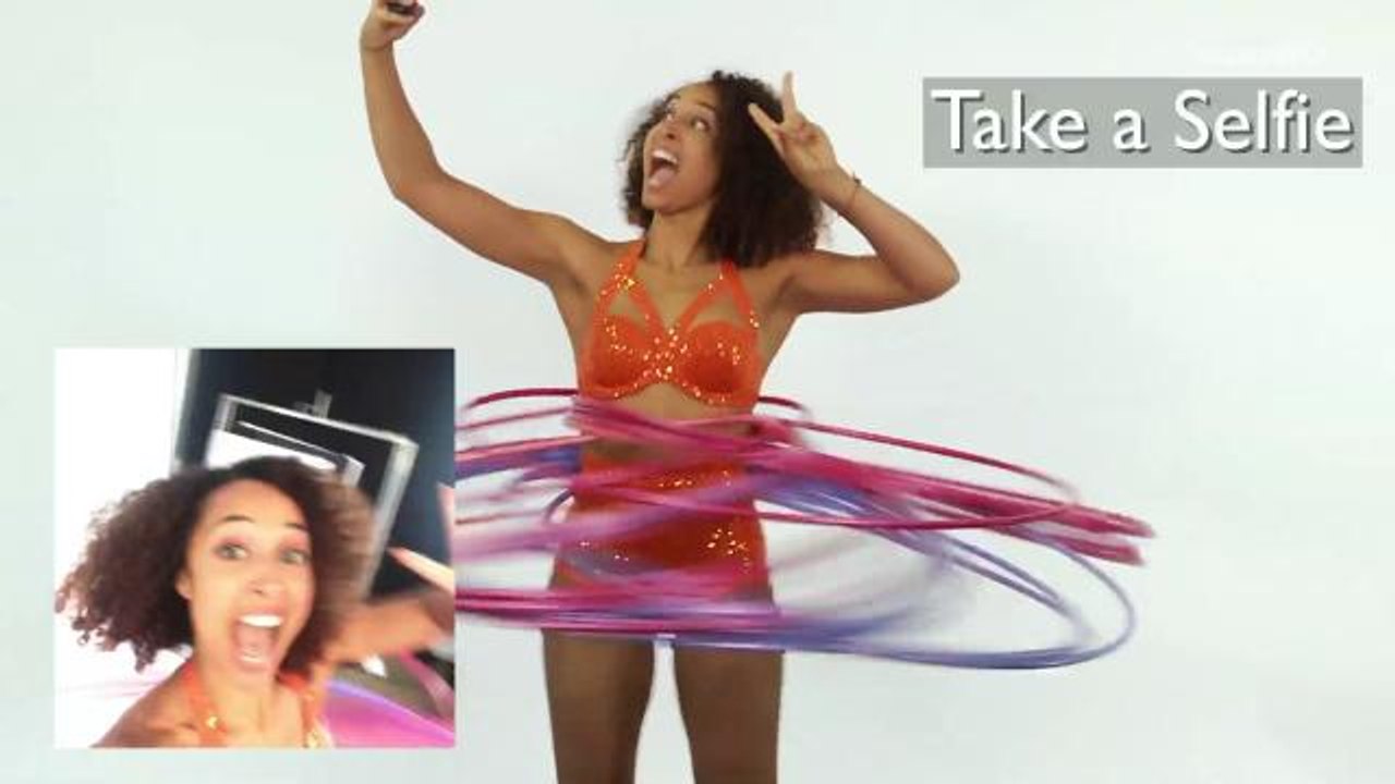 Guinness World Records holder hula hoops while attempting everyday tasks