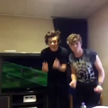 Harry Styles of One Direction dancing with Ashton Irwin of 5SOS