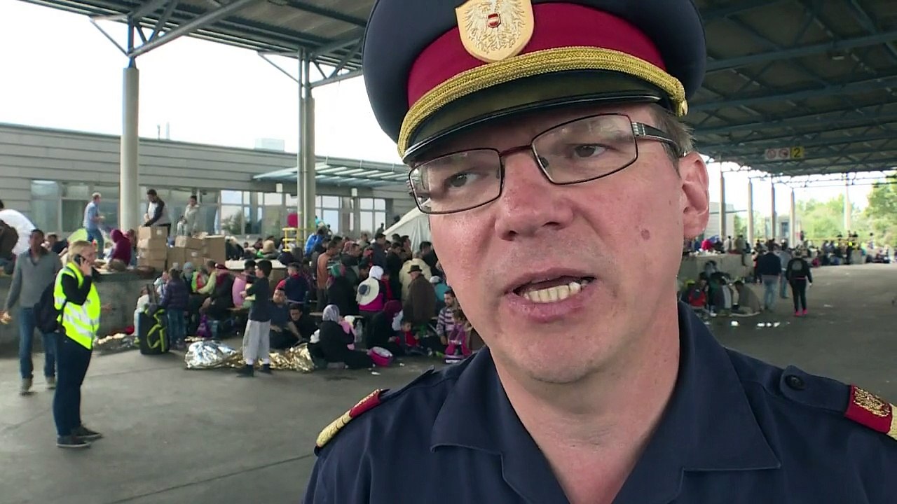 Migrants walk into Austria from Hungary after train suspended