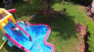 Aerial Drone Footage of Kids Playing on Banzai Slide and Splash Water Slide