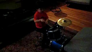 Shiraz' very first sitting on a drum kit, 2 years old