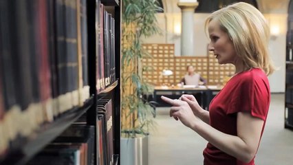 A Blonde comes into the library