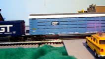 Lionel Grand Trunk Western GP7 and Switcher roll through the grade crossing with heavy freight.