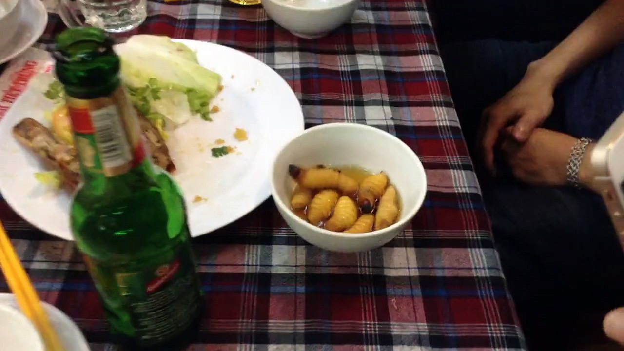 Eating alive big white worms in Vietnam