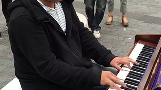 The street musician from Taiwan plays Let It Be on the street in Liverpool