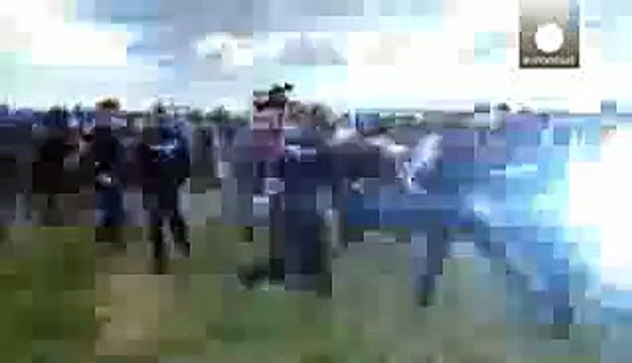 Hungarian camera woman caught on video kicking and tripping migrants