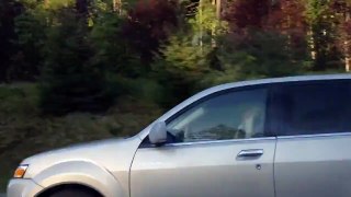 Woman Curls Her Hair While Driving Her Car