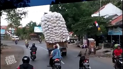 TRUCK TAKES TUMBLE--OVERLOADED