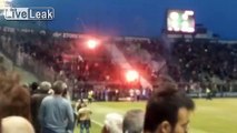 Rival supporters threw flares and seats at each other and riot police.