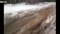 Overloaded truck overturns in a Siberian highway