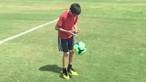 Kid Juggles Soccer Ball While Solving Rubik's Cube