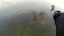 Jeb Corliss Flies Through 10ft Gap In Cliff