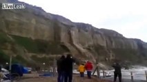 cliff collapse sussex uk and waves crashing over Aberystwyth seafront Wales storms set to get worse
