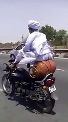 Indian old man biking with feet