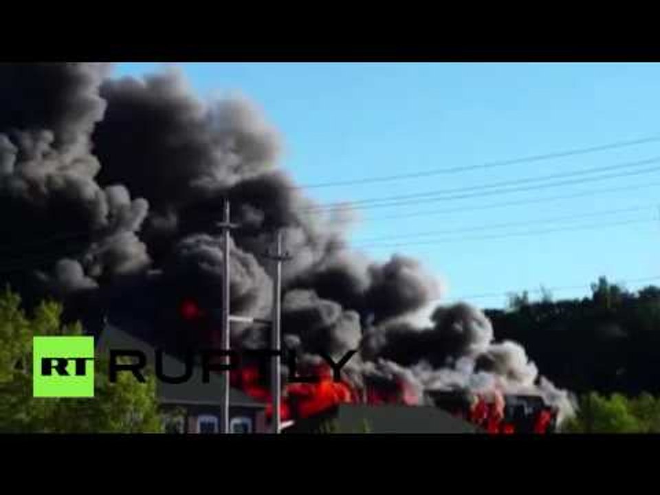 RAW: Huge plumes of black smoke billow from burning Massachusetts mill