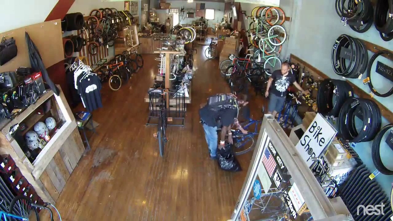 Thief gets caught at bike shop and ejected out with his bike!