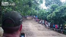 Spectator tries to ride injured pro's bike down the track.  Doesn't go too well